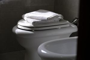 a bathroom with a white toilet and a sink at Villa con giardino in Pontecurone +10 photos