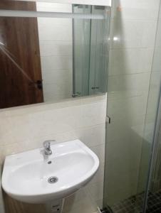 a bathroom with a sink and a glass shower at للا ربيعة بيتي in Kenitra +16 photos
