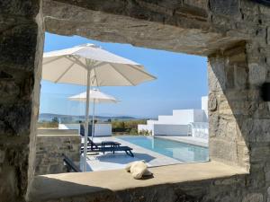 a teddy bear sitting on a bench next to a pool at GBR 2 - Golden Beach Residences in Chrissi Akti
