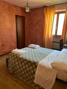 a hotel room with a bed and a window at Albergo Bar Brenve in Issogne +10 photos