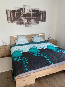 a bedroom with a bed with a picture on the wall at Rosemary Cottage in Solt
