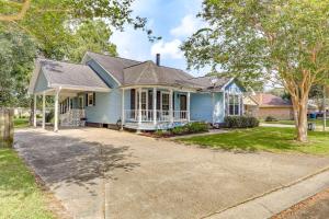 a blue house with a driveway in front of it at 5 Mi to Downtown Morgan City Waterfront Retreat in Morgan City