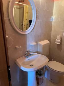 a bathroom with a sink and a toilet and a mirror at Albergo Bar Brenve in Issogne