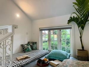 a room with a bed and a large window at Sun-kissed Holidays, Goa - Copper in Serula +30 photos