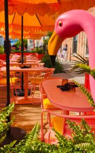 a bunch of tables and chairs with a pink flamingo at The Ayrshire Hotel in Elora