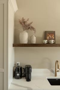 a kitchen counter with a coffee maker and a sink at The Ayrshire Hotel in Elora