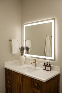 a bathroom with a sink and a large mirror at The Ayrshire Hotel in Elora +17 photos