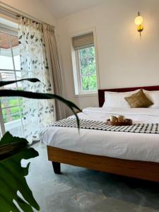 a bedroom with a bed with a plate of food on it at Sun-kissed Holidays, Goa - Copper in Serula
