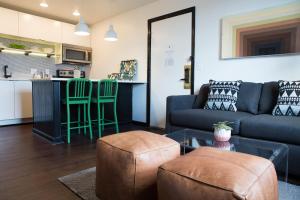 a living room with a couch and a table at Sleeps 8 4 SoBro Suites w Kitchens Art Walk to Broadway – by AvantStay in Nashville
