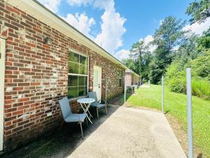 a brick building with two chairs and a table at Chateau 8 in Hammond