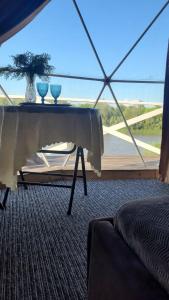 a room with a table with two vases on it at Глемпінг Еко-сфера in Dubovtsy +3 photos