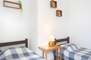 Ένα ή περισσότερα κρεβάτια σε δωμάτιο στο Cobertura Frente a 1 min da Prainha - Vista Ampla