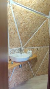 a bathroom with a sink on a stone wall at Глемпінг Еко-сфера in Dubovtsy