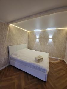 a small room with a bed with lights on it at Апартаменты 2 in Karagandy
