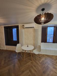 a living room with a table and two chairs at Апартаменты 2 in Karagandy