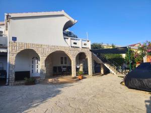 a building with arches and a staircase on it at Apartment Vir in Vir