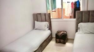 a room with two beds and a window at M'Diq Minute Walk-1st Floor in M'diq