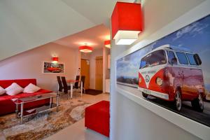 a living room with a painting of a van on the wall at StaraPolana.EU & SPA in Zakopane