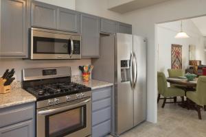 a kitchen with a stove and a stainless steel refrigerator at Elegant and updated - In the heart of Sedona in Sedona
