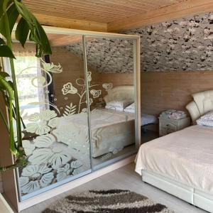a bedroom with a bed and a glass wall at Едем in Verkhovyna