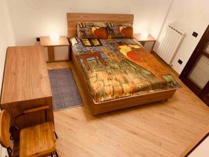 a bedroom with a bed and a wooden desk at Silvios House Nuovissimo appartamento moderno con box auto in Sassari