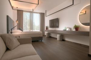 a hotel room with a bed and a mirror at 1779 SUITES Kežmarok in Kežmarok