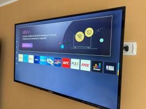 a television screen with a program on it at Apartament Leonardo in Roman +4 photos