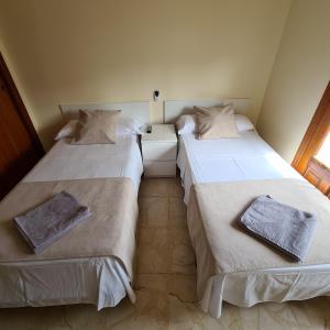 a bedroom with two beds and a window at H Los Rafaeles in Torrejón de Ardoz +9 photos