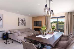 a living room with a table and a couch at Villa Perla in Poreč