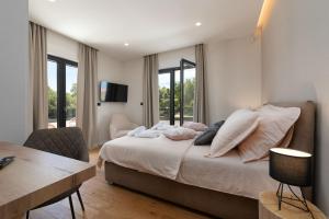 a bedroom with a large bed with a desk and a chair at Villa Perla in Poreč +40 photos