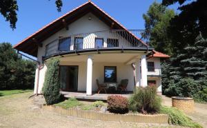 a house with a balcony on top of it at Dom pod Górskim Niebem in Kobiernice