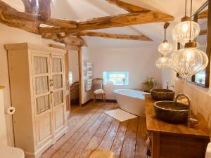 a bathroom with a tub and a sink at Le Domaine des Tilleuls in Mareuil +72 photos
