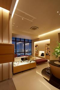 a large living room with a large window at Candeo Hotels Matsuyama Okaido in Matsuyama