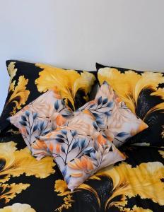 a bed with two pillows on top of it at Apartament słoneczny in Rydułtowy