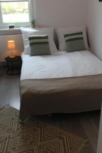 a large bed in a bedroom with a lamp at Nocleg pod Ksiązem in Wałbrzych