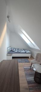 a white room with a bed and a couch at Garden Baltic II in Trzęsacz