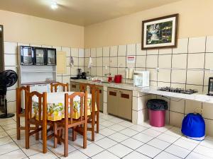 a kitchen with a table and chairs in a room at Hotel Terra Mãe in Belém