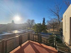 a balcony of a building with the sun in the sky at VMdormis in Neuquén