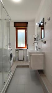 a bathroom with a sink and a shower and a toilet at Silvi Marina - Appartamenti Sesia in Silvi Marina