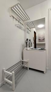 a white room with a counter and a bench at Silvi Marina - Appartamenti Sesia in Silvi Marina