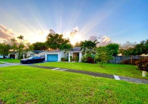 a house with a car parked in a yard at BEAUTIFUL POOL HOME 2 beds 1 Bath FT LAUDERDALE,MIAMI in Cooper City