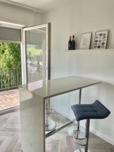 una scrivania con sedia blu in una stanza con finestra di REHBLICK Ferienwohnung a Trösel