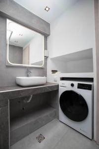 a bathroom with a washing machine and a sink at Ilissos Harmony Apartment in Piraeus