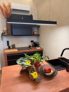 a kitchen with a table with fruits and vegetables on it at Villa Duna Maria in Fuzeta +14 photos