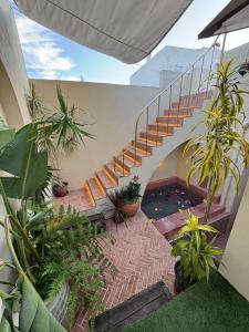 a staircase in a house with plants at Villa Duna Maria in Fuzeta