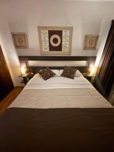 a bedroom with a large white bed with two pillows at Edificio Waikiki in Mar del Plata +29 photos