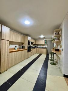 a kitchen with wooden cabinets and a black and white floor at 313homebogotá in Bogotá +20 photos