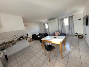 a living room with a table and a couch at Alojamiento Cerro de la Cruz in San Luis +2 photos