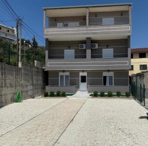 a building with a stone driveway in front of it at Miltons House in Vlorë