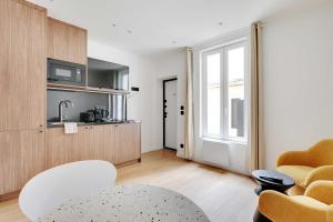 a living room with a couch and a table at Residence Raspail - Montreuil in Montreuil